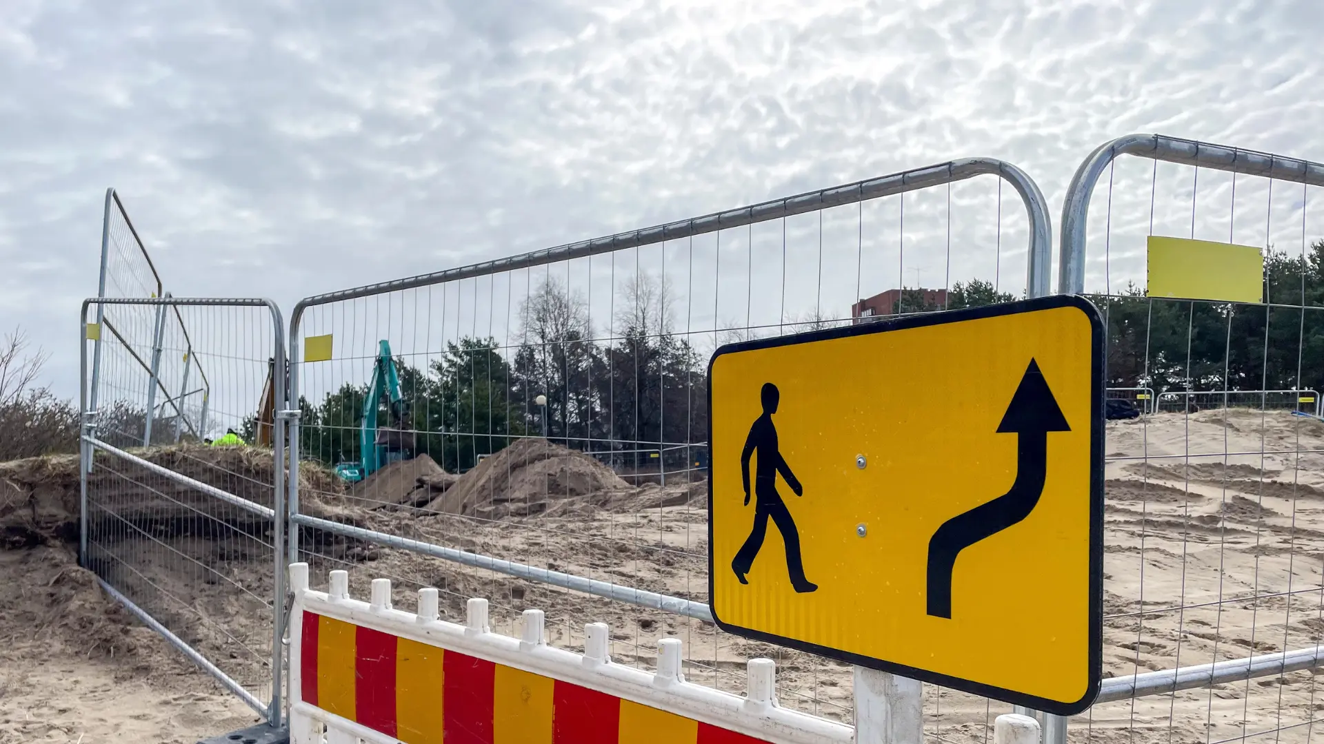 Construction site pedestrian diversion sign with temporary security fencing