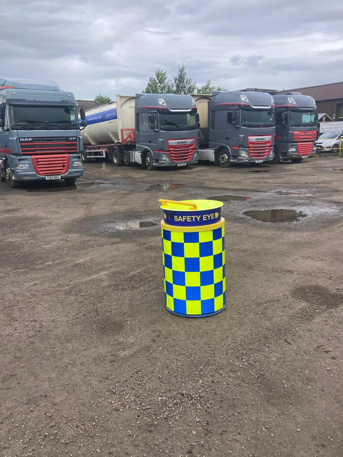 Safety Eye CCTV bollard monitoring HGV truck depot yard with multiple trucks parked