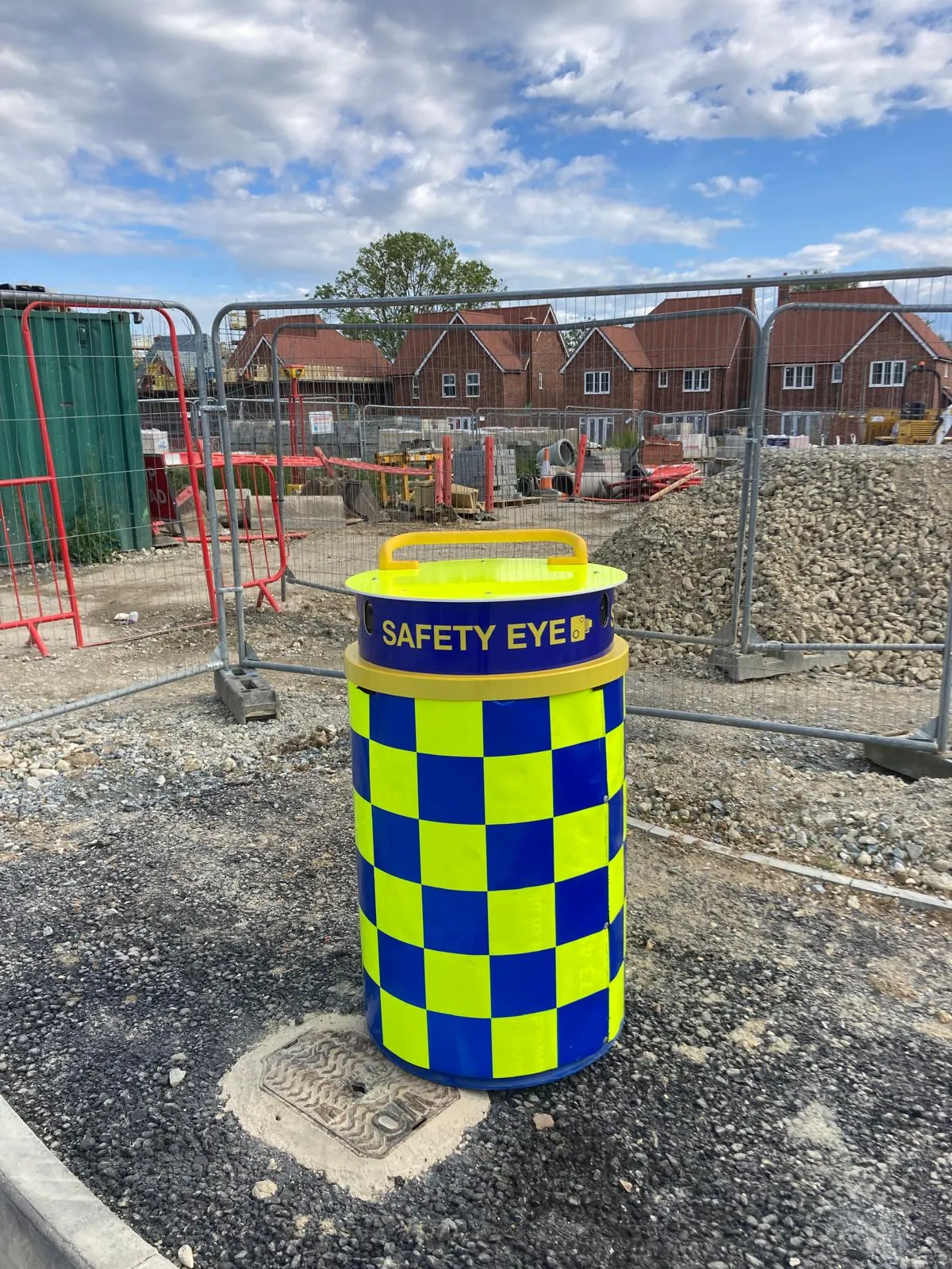 Safety Eye monitoring bollard at housing development construction site with new homes in background