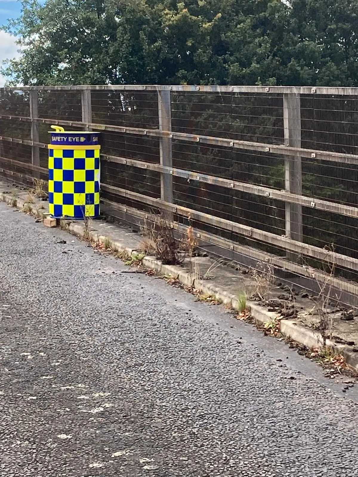 Safety Eye monitoring bollard on road bridge with security fencing for site protection
