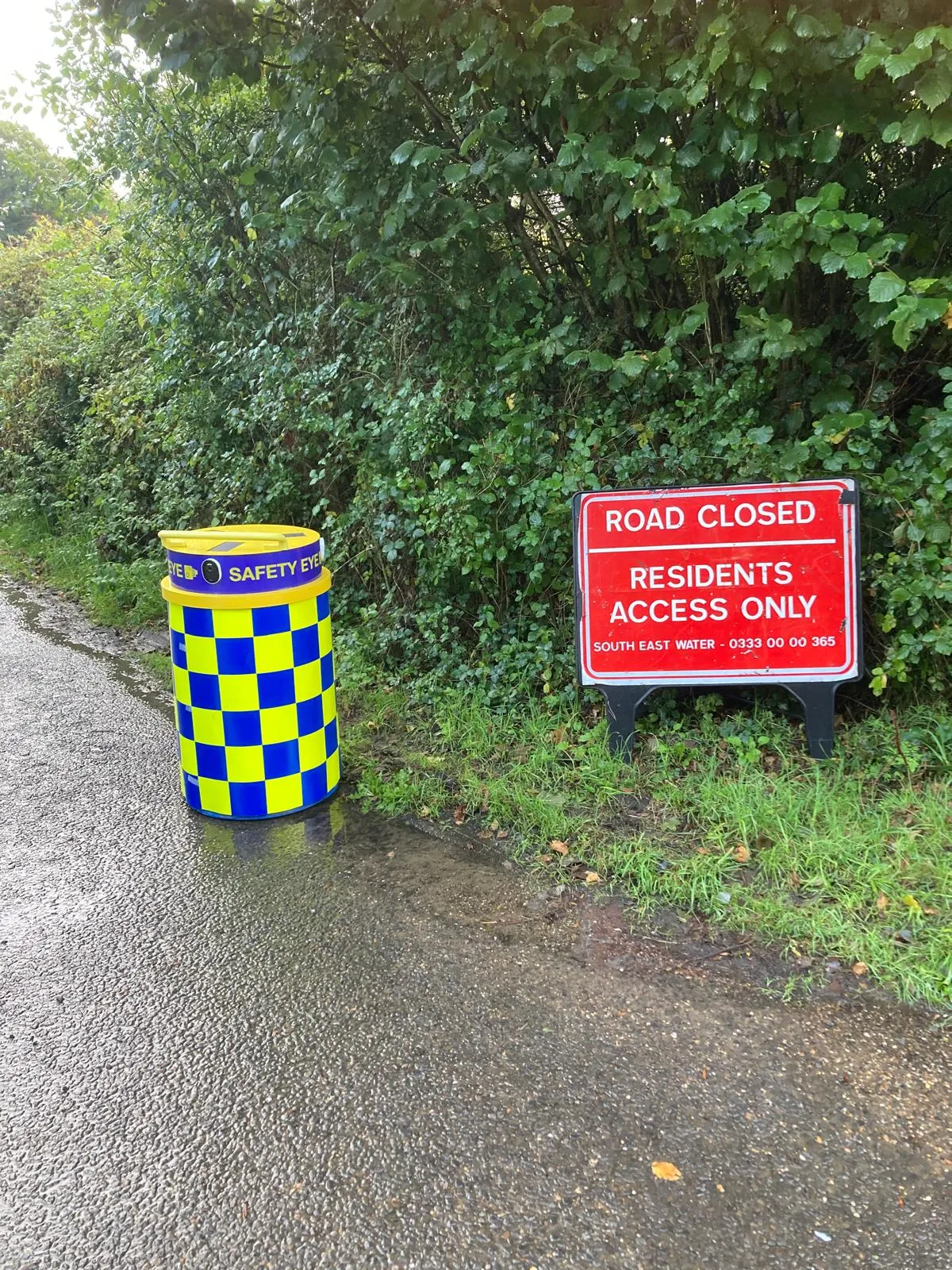 Safety Eye CCTV bollard next to road closed residents access only sign during utility works