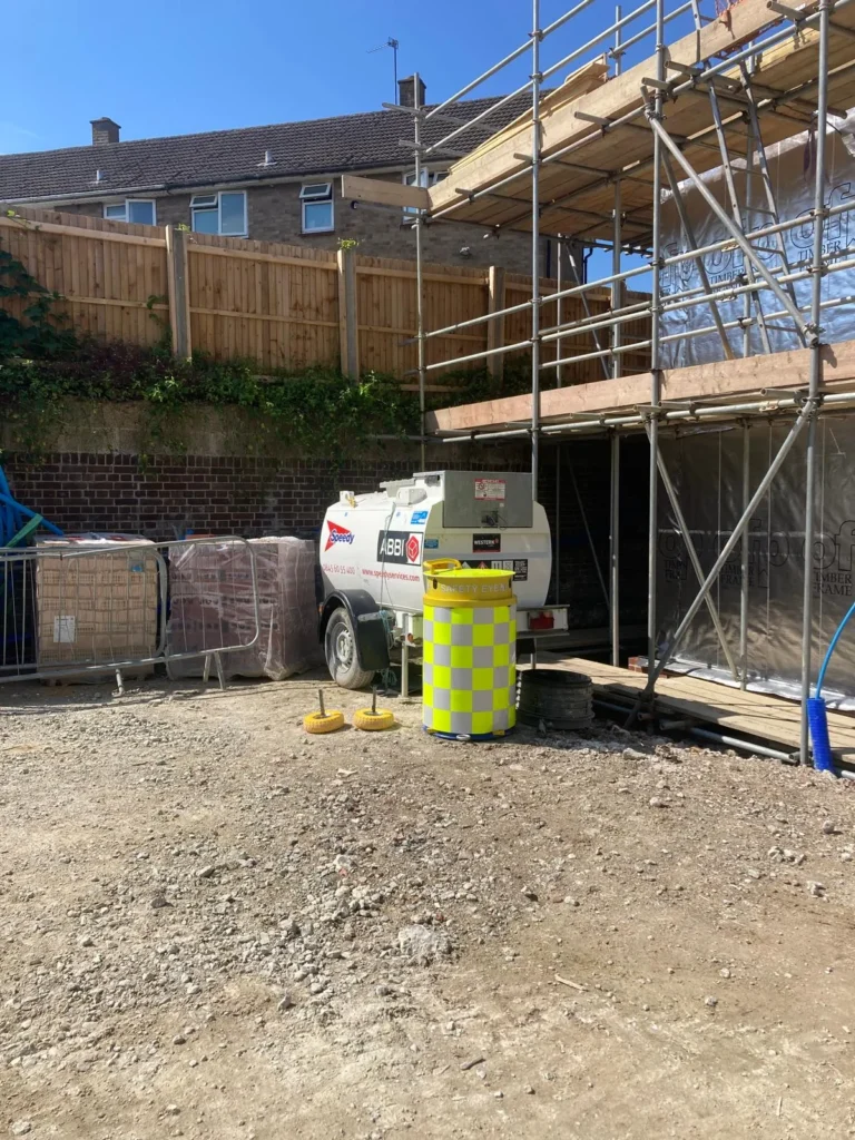 Safety Eye CCTV bollard monitoring a new build construction site with scaffolding and a fuel tank