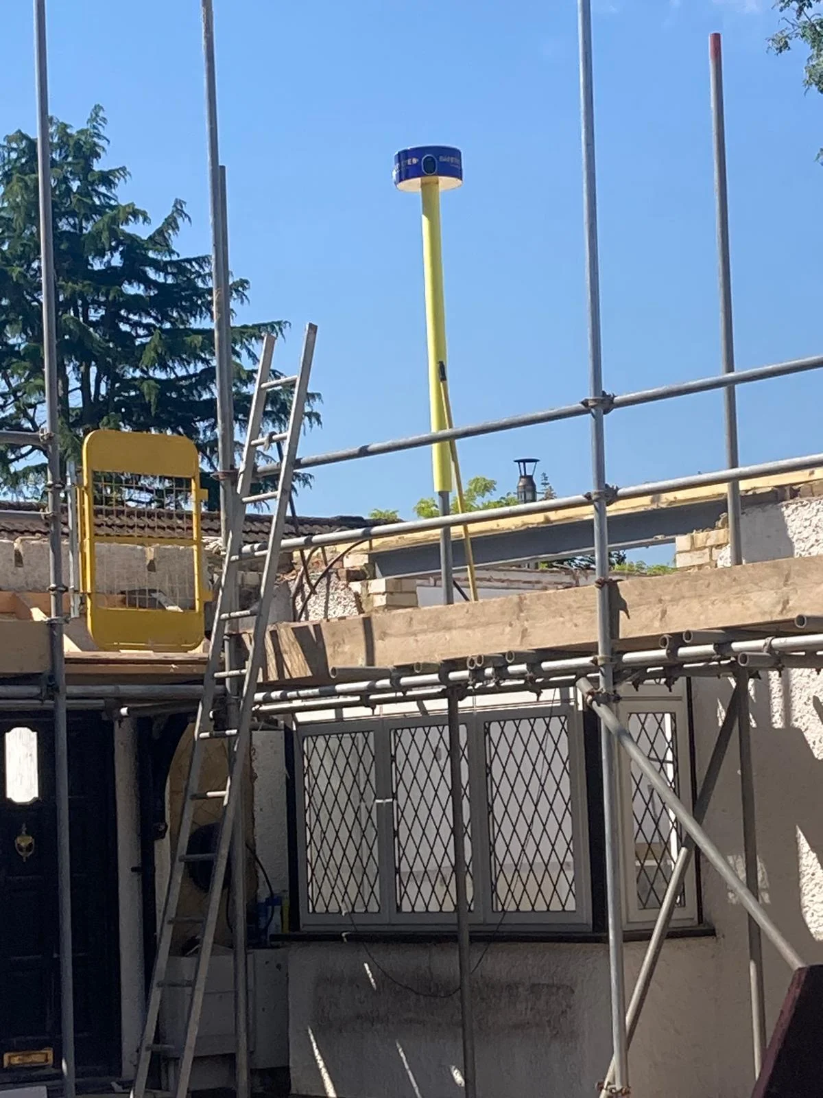 Safety Eye bollard mounted above scaffolding at a residential renovation site